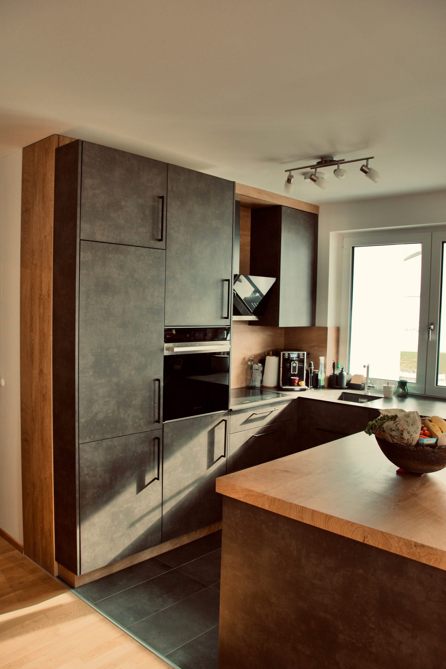 A kitchen with a bowl of fruit on the counter photo