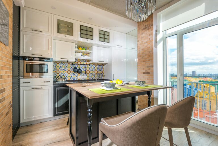 Kitchen Area with White Cabinetry and Full Wall Glass Panel