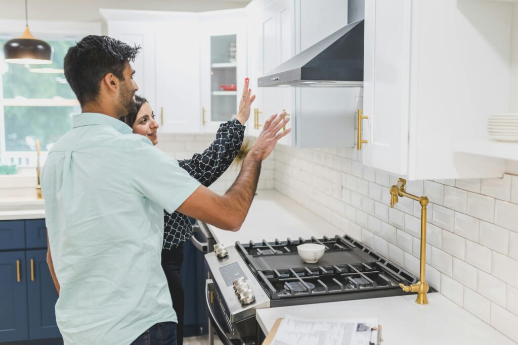 Couple evaluating cabinets in a kitchen